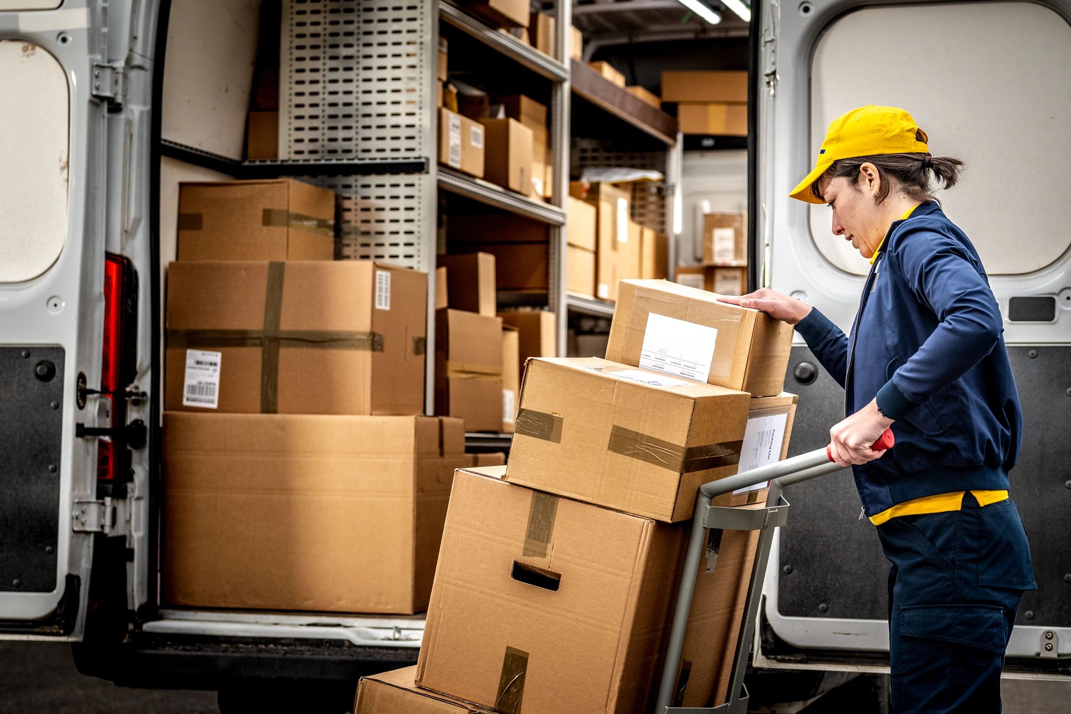 Courier handling parcels in a warehouse