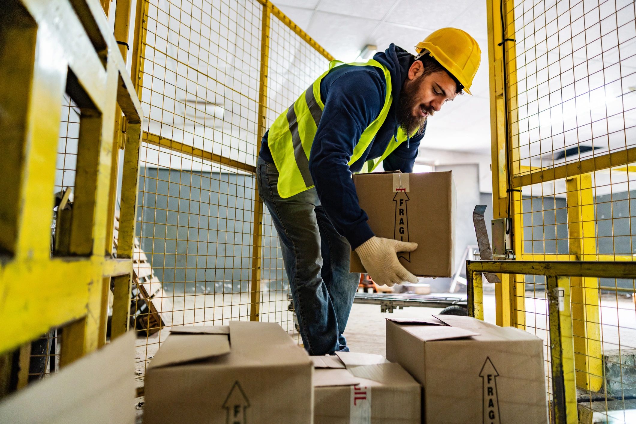 Warehouse worker handling packaged boxes for shipment