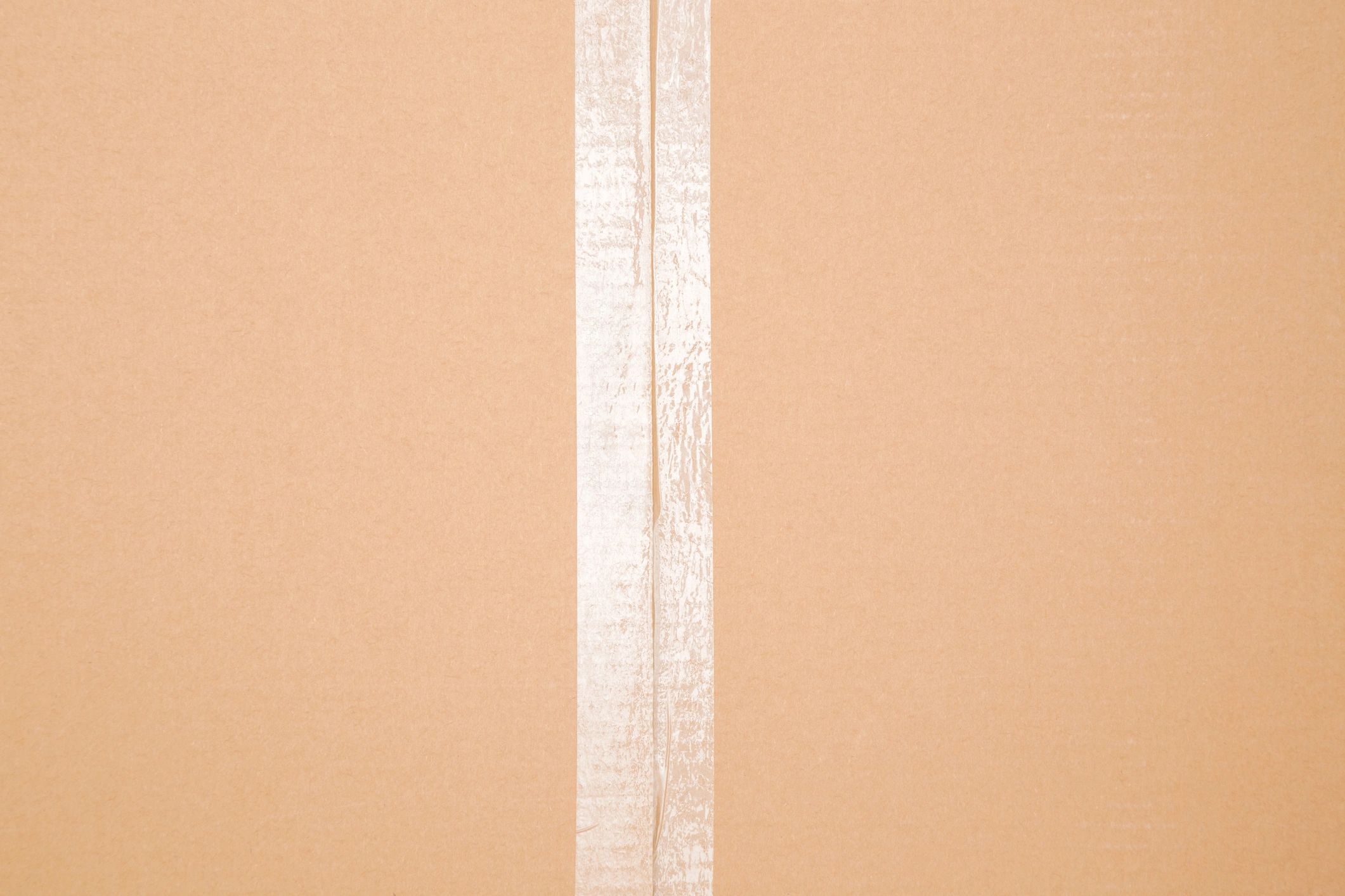 Close-up of a sealed cardboard carton with clear packing tape