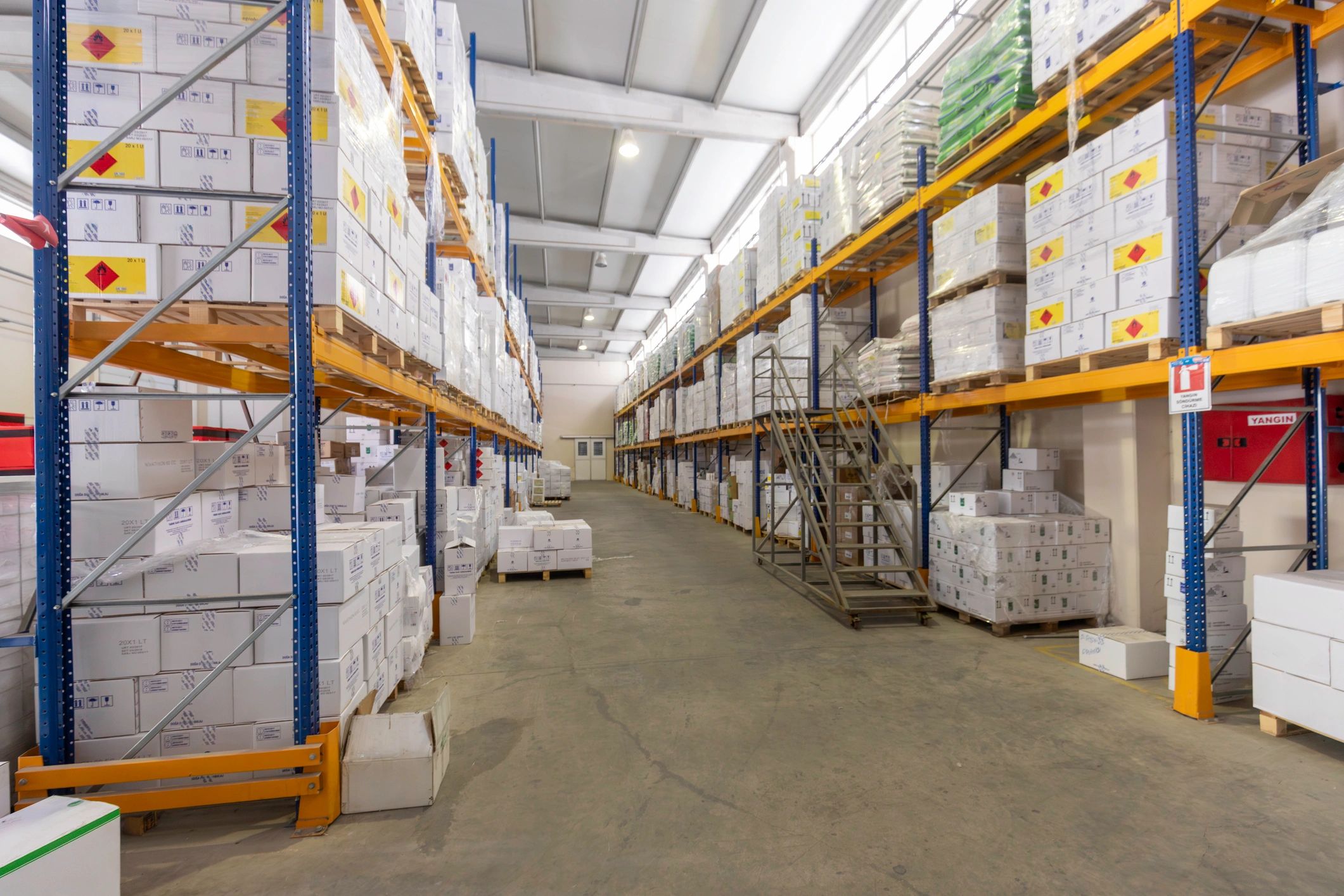 Organized warehouse aisle with shelving and boxes