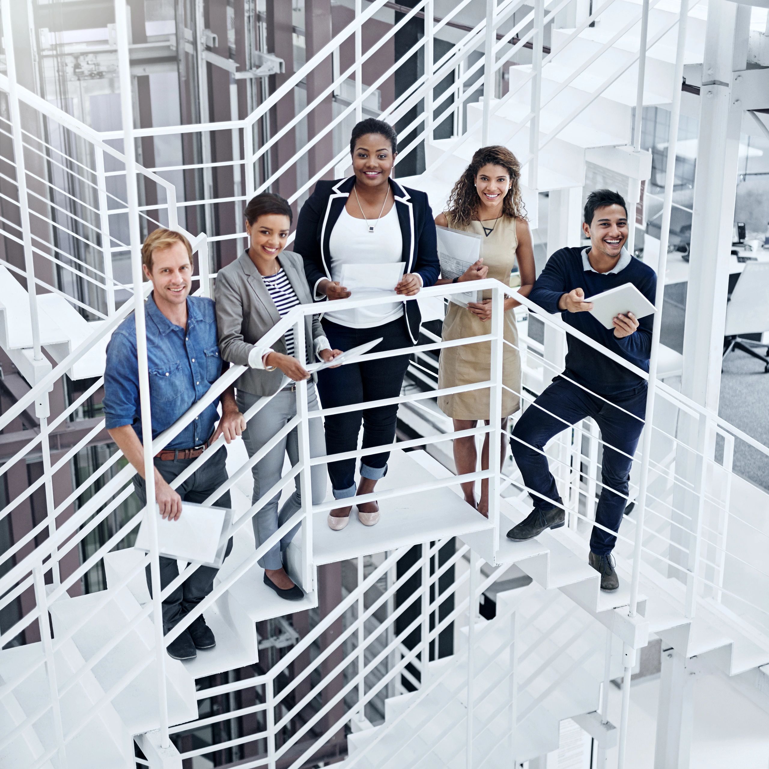 Group of coworkers standing together in a modern office